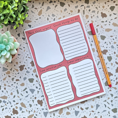 The A5 Rainbow Priority Task List 3 features four sections for organising tasks by urgency. Shown with a yellow pen and a small succulent on a terrazzo surface.