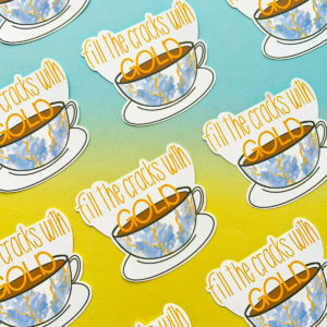 Stickers all with the same design are spaced evenly in diagonal rows going across the image. A porcelain cup and saucer. The cup has cracks filled with gold ink. Above is the text 'fill the cracks with gold'. The image has a blue to yellow hombre effect background.