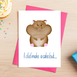 Hamster Greeting Card 4 comes with a pink envelope and features a cute, chubby brown hamster and the text “I did make a cake but…”; cupcake, confetti, and a blue box sit on a wooden table background.